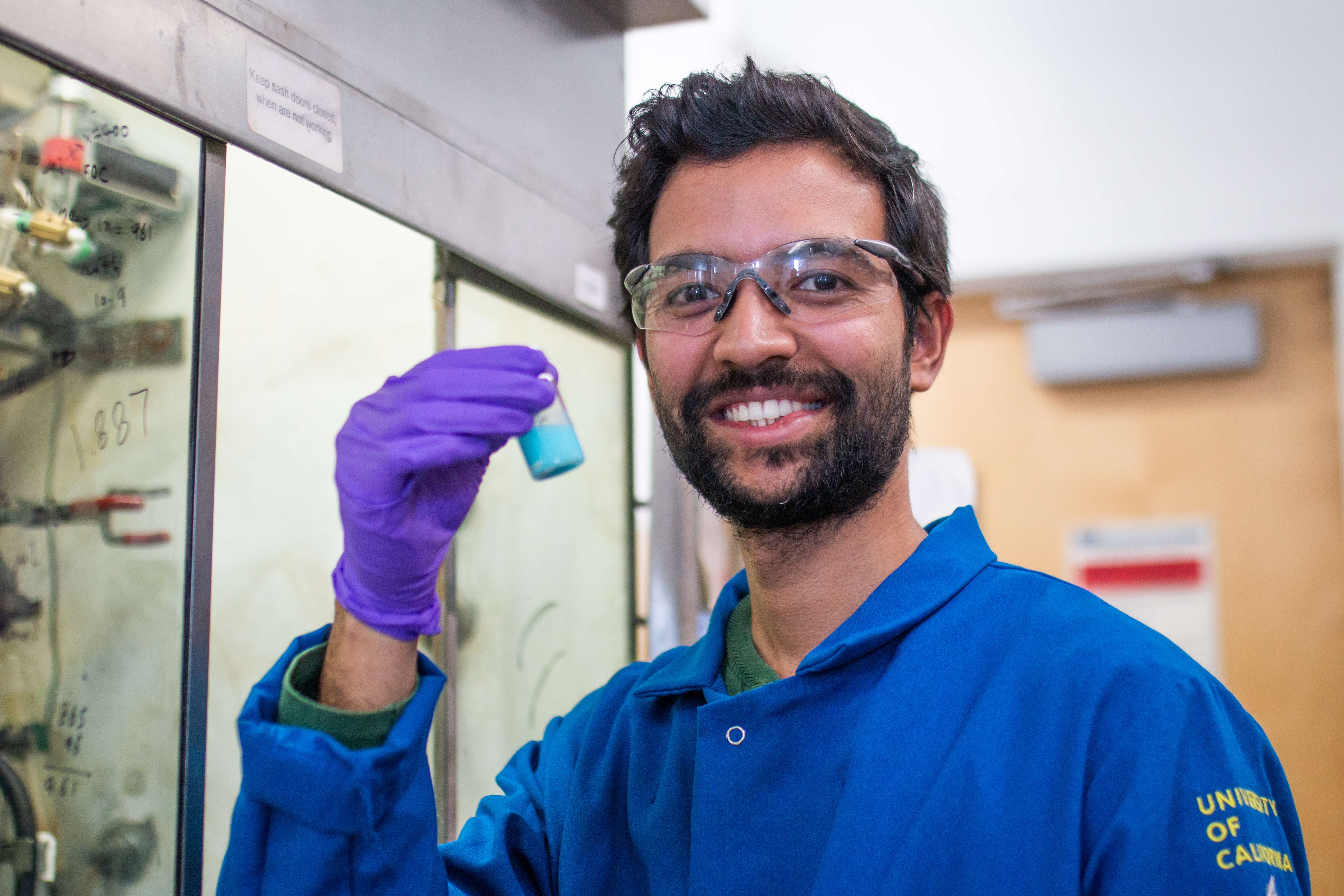 A UC Berkeley scholar smiles while working at the Yaghi Lab in Berkeley, Calif. (Photo / Kayla Sim / UC Berkeley College of Computing, Data Science, and Society)