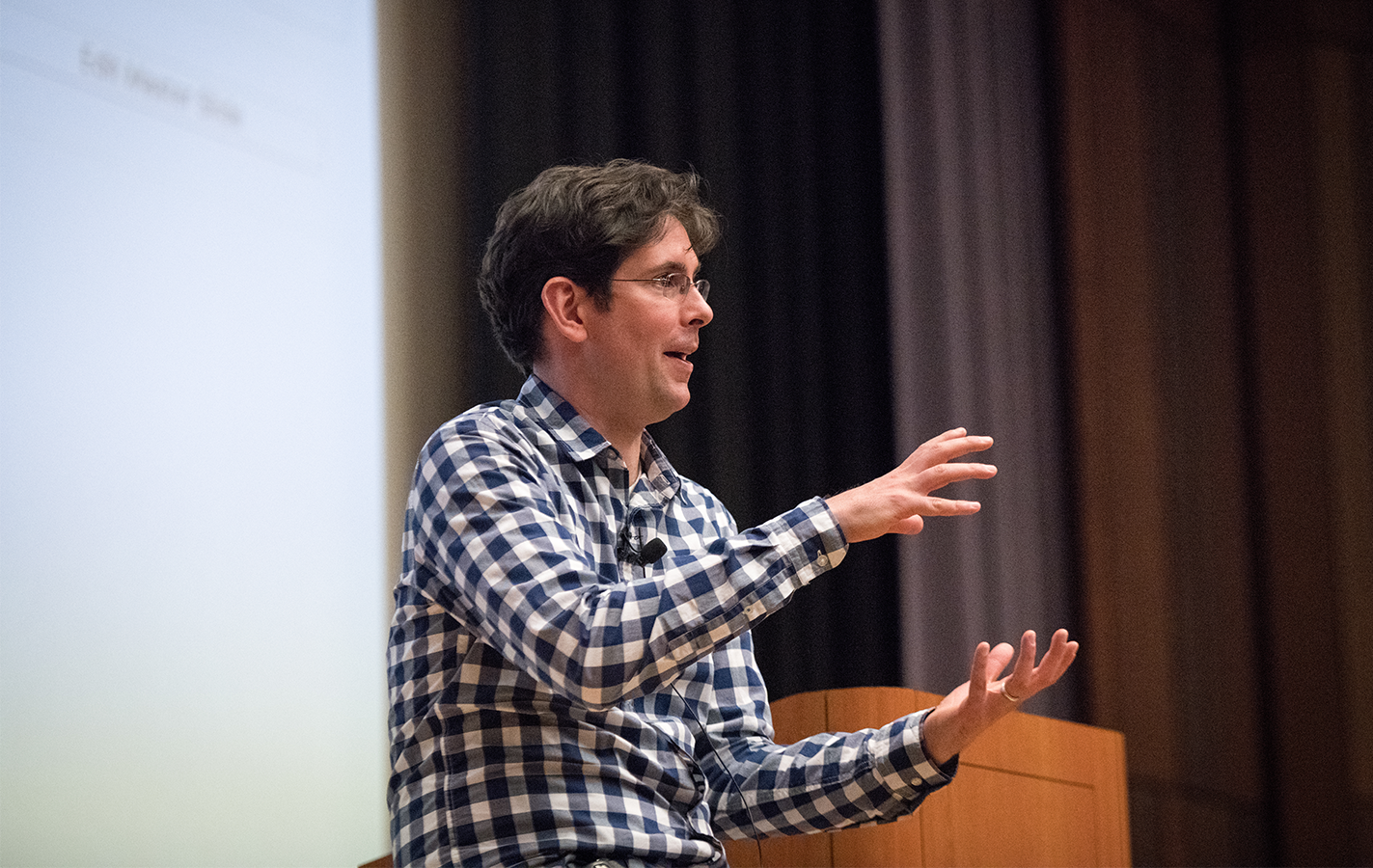 Professor John DeNero lecturing at front of Berkeley classroom