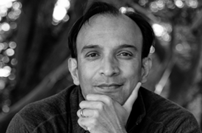 Black and white portrait of DJ Patil with his hand resting on his face