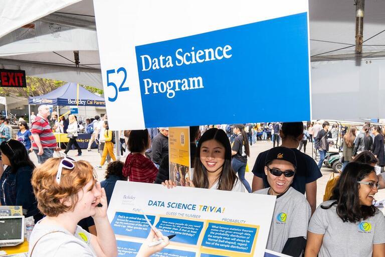 group of people and a sign saying data science program