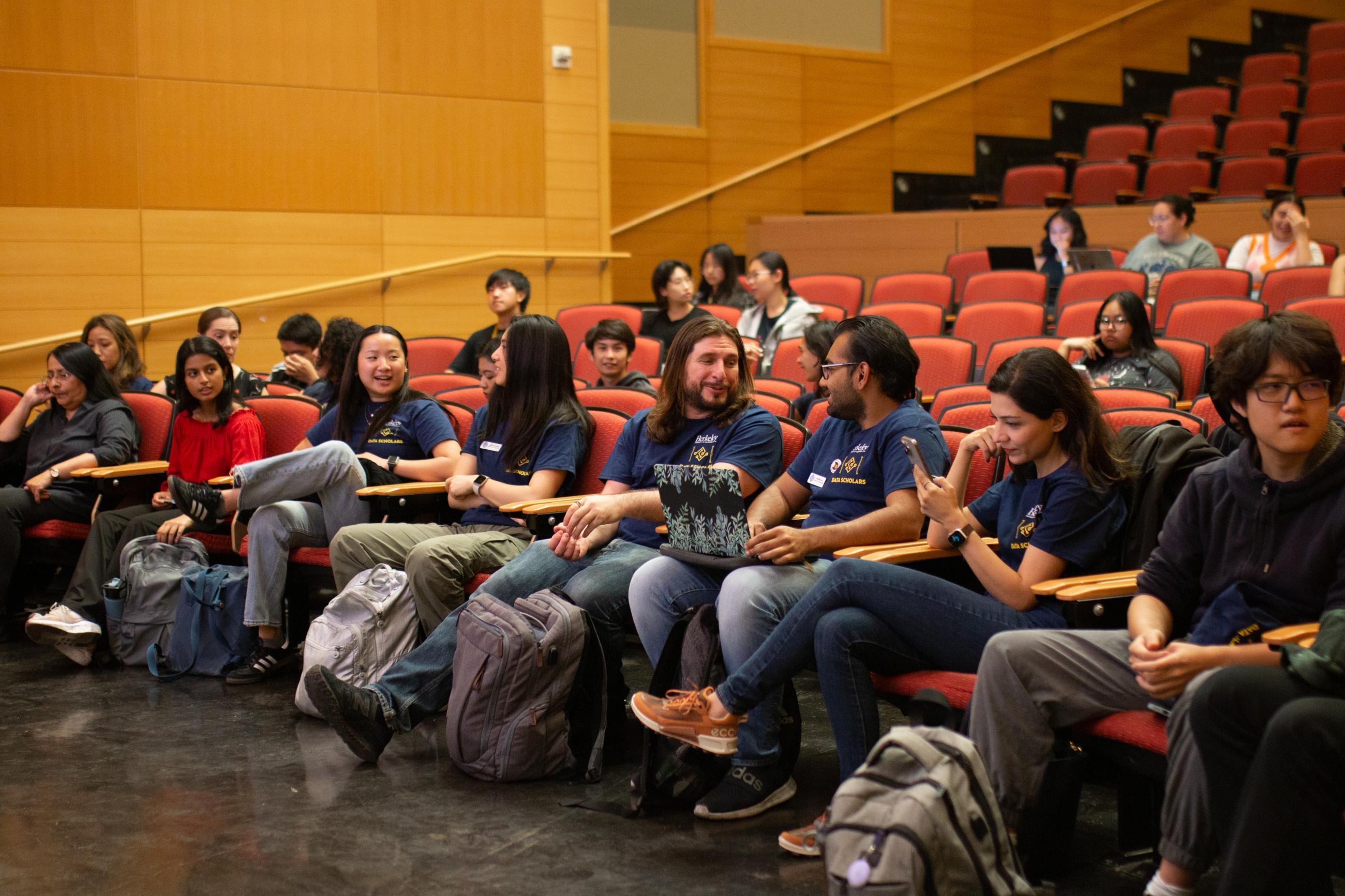 Data Science students talk together in a lecture hall